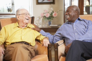 picture of two old men sitting on a couch having a good time