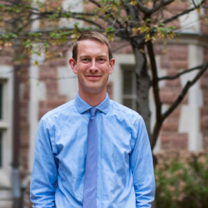 Professor Patrick Hill standing outside on campus