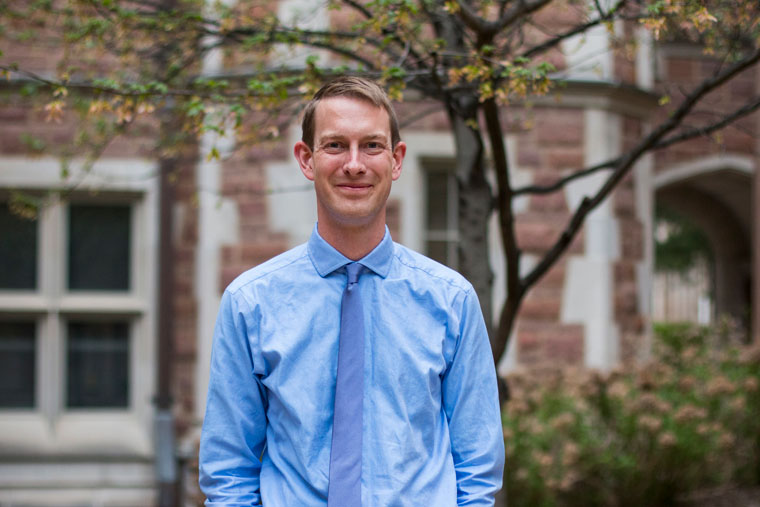 Professor Patrick Hill standing outside on campus