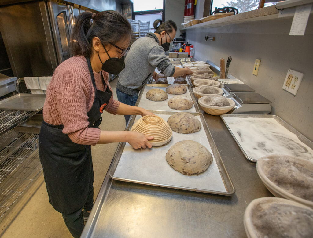 Leah Yeh prepares loaves of Berry Trio Walnut bread nex to Raymond Yeh