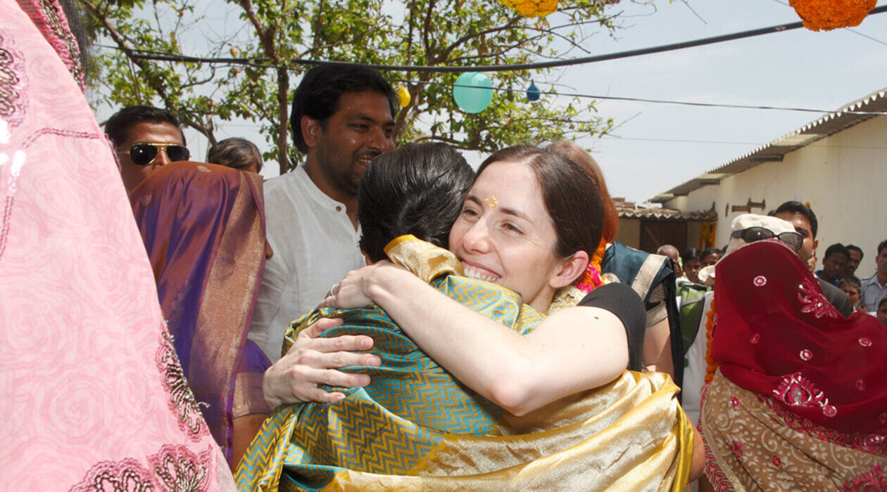 Nest founder, Rebecca Van Buren hugs a global artisan in South Asian