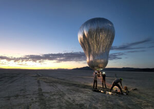 balloon inflating above the desert at sunrise