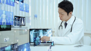 Doctor pointing to a medical scan image on a laptop, surrounded by digital images
