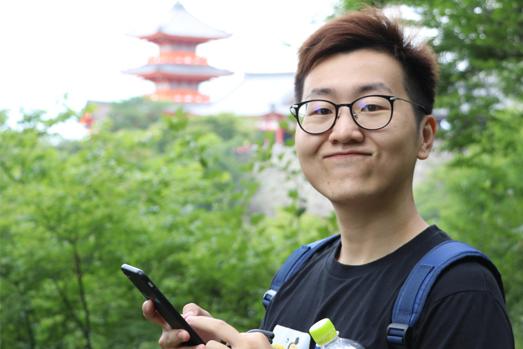 Headshot of Yun Zhu, standing outside