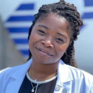 Portrait of author and Washington University alumna Jasmine Brown wearing a lab coat.