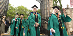 The Class of 1973 enters Francis Olympic Field on May 15. For Barbara Lewis (right), the day had an extra special component.