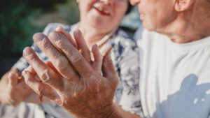 Older adults holding hands