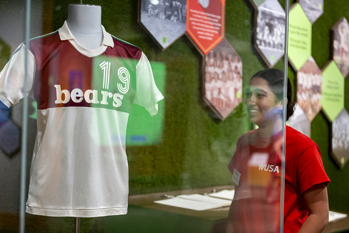 Washington University student looks at an old Bears uniform at the Missouri History Museum