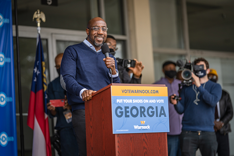 U.S. Senator Raphael Warnock speaking at a campaign event