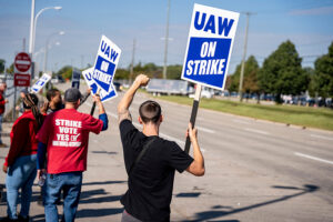 United Auto Workers on strike holding up signs at Ford assembly plant in Wayne, Mich.