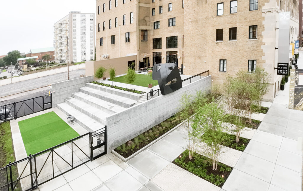 Elevated view of hotel courtyard, showing sculpture at center.