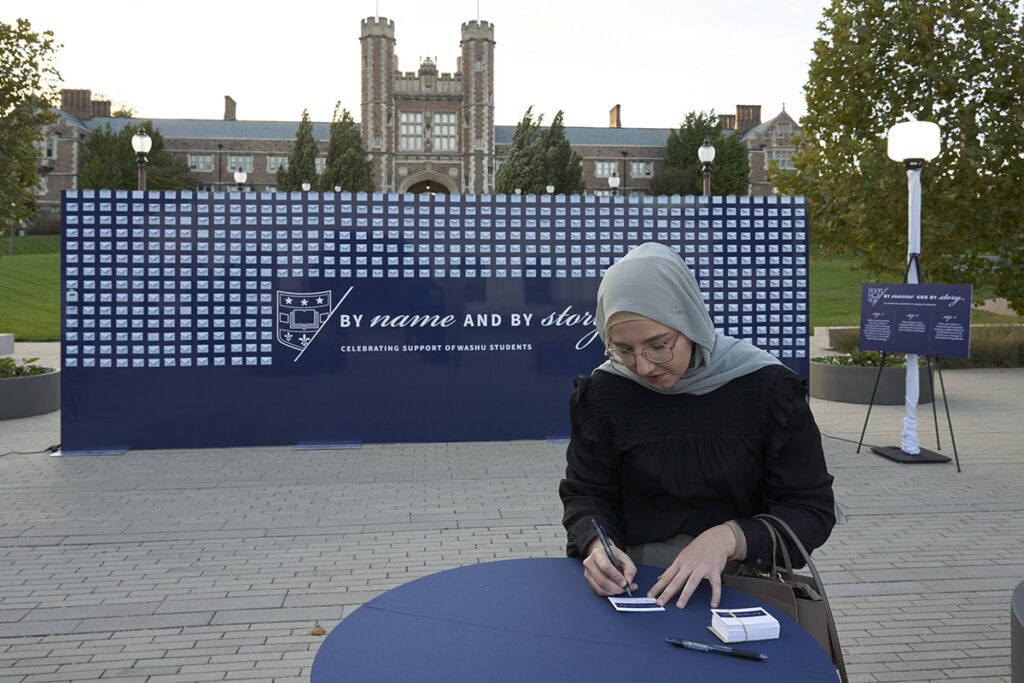 An attendee fills out a card