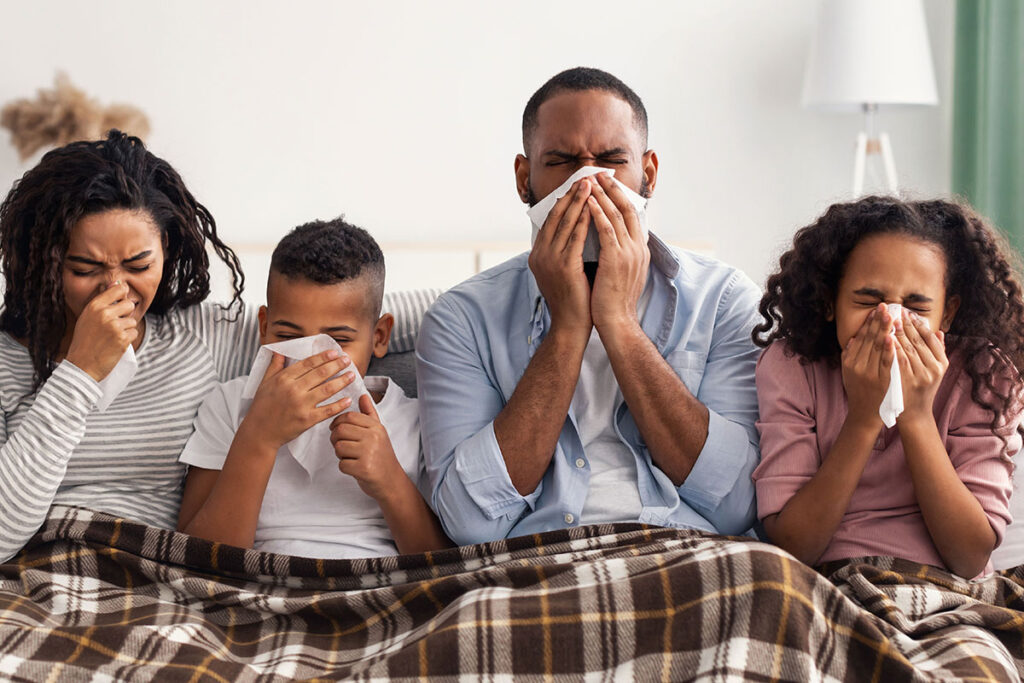 family blowing noses