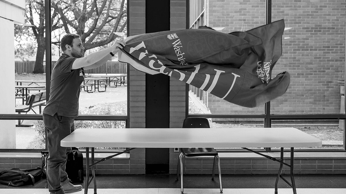 Dacoda Scarlett sets up a table at Quincy High School