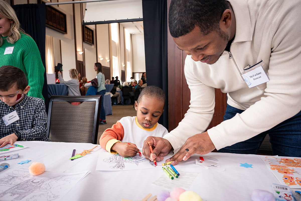 WashU employee colors with child