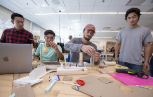 students in engineering class design prototypes