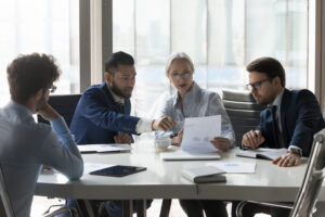 Office workers having a discussion around a conference table