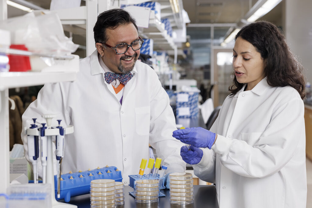 Researchers including Gautam Dantas, PhD (left); Beau Ances, MD, PhD (not shown); and postdoctoral researcher Aura Ferreiro, PhD (right), showed in a 2023 published study that the microbiome is already significantly different in the earliest stage of Alzheimer’s disease — after brain changes have begun but before cognitive symptoms become apparent. (Photo: Matt Miller/Washington University School of Medicine)