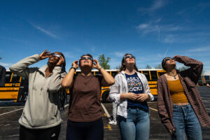 A group looks up at the sky during the solar eclipse
