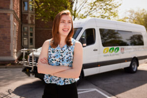 Lauren Bruhl in front of an electric shuttle