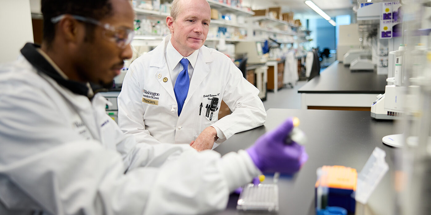 Randall Bateman, MD (right), director of the Dominantly Inherited Alzheimer Network (DIAN) and founding director of the DIAN-Trials Unit (DIAN-TU), confers with research technician Olatayo Ajenifuja. In his lab in the Jeffrey T. Fort Neuroscience Research Building, Bateman trains junior faculty, postdoctoral fellows, graduate students and undergraduates as they investigate the causes and methods of diagnosis and treatment of Alzheimer’s disease by using a wide variety of assays and techniques. (Photo: Matt Miller/Washington University School of Medicine)