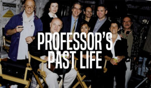 Richard Chapman in a director's chair surrounded by others