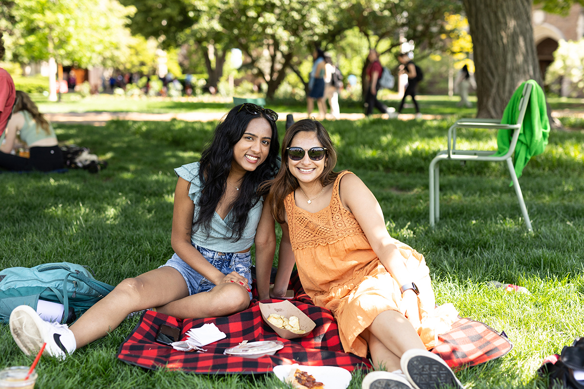 Students sit together outside