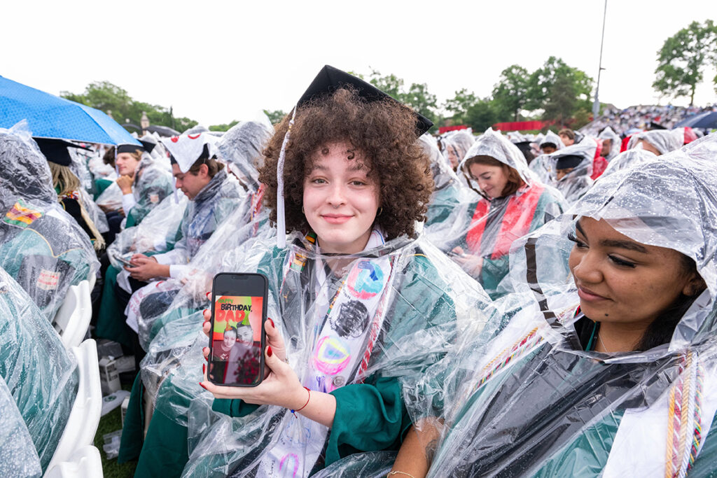 Graduate poses with her phone