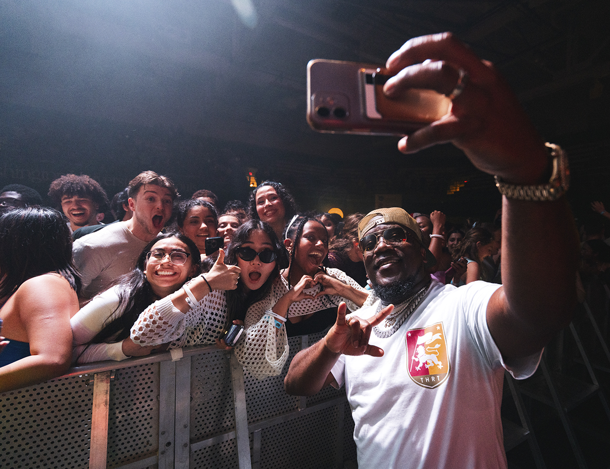 Singer poses with students