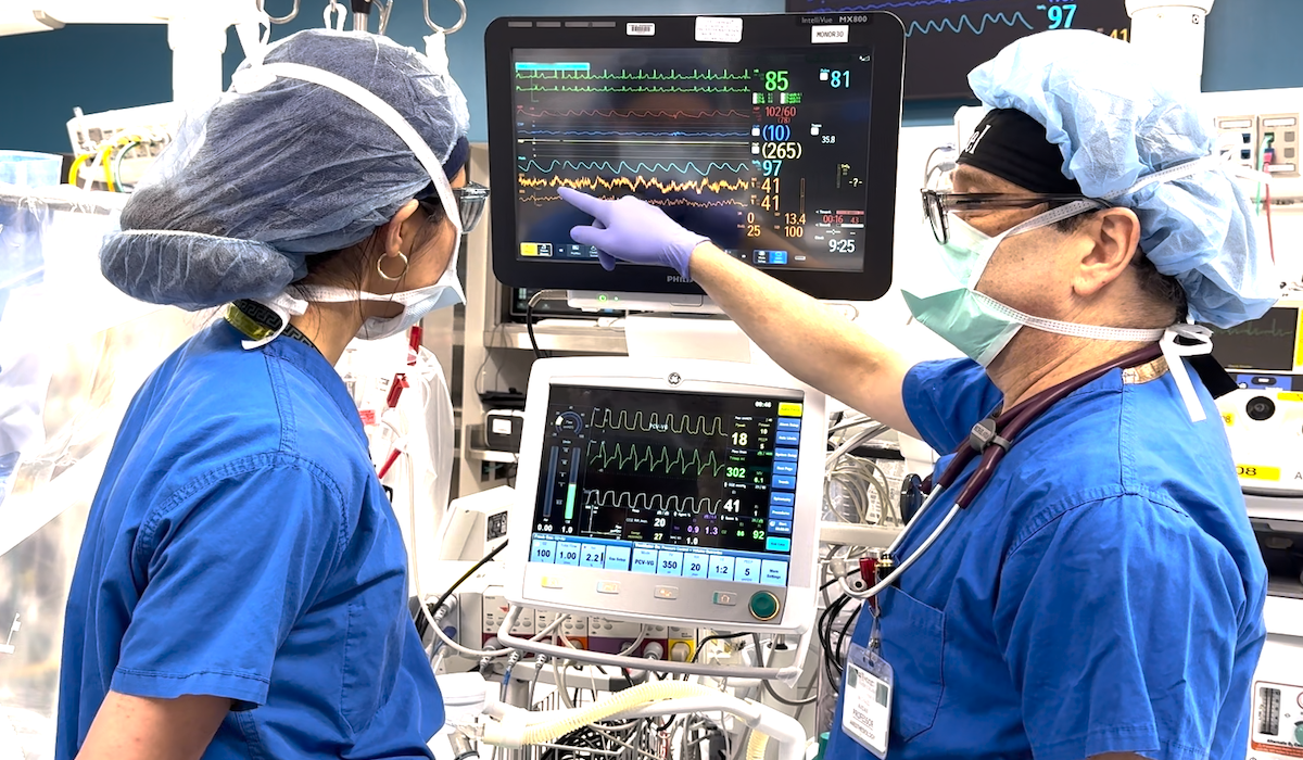 doctor administers anesthesia during surgery