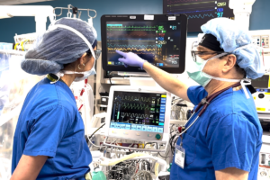 doctor administers anesthesia during surgery