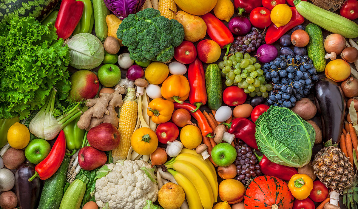 Vegetables and fruits large overhead mix group on colorful background in studio