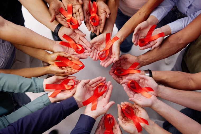 hands holding AIDS ribbons