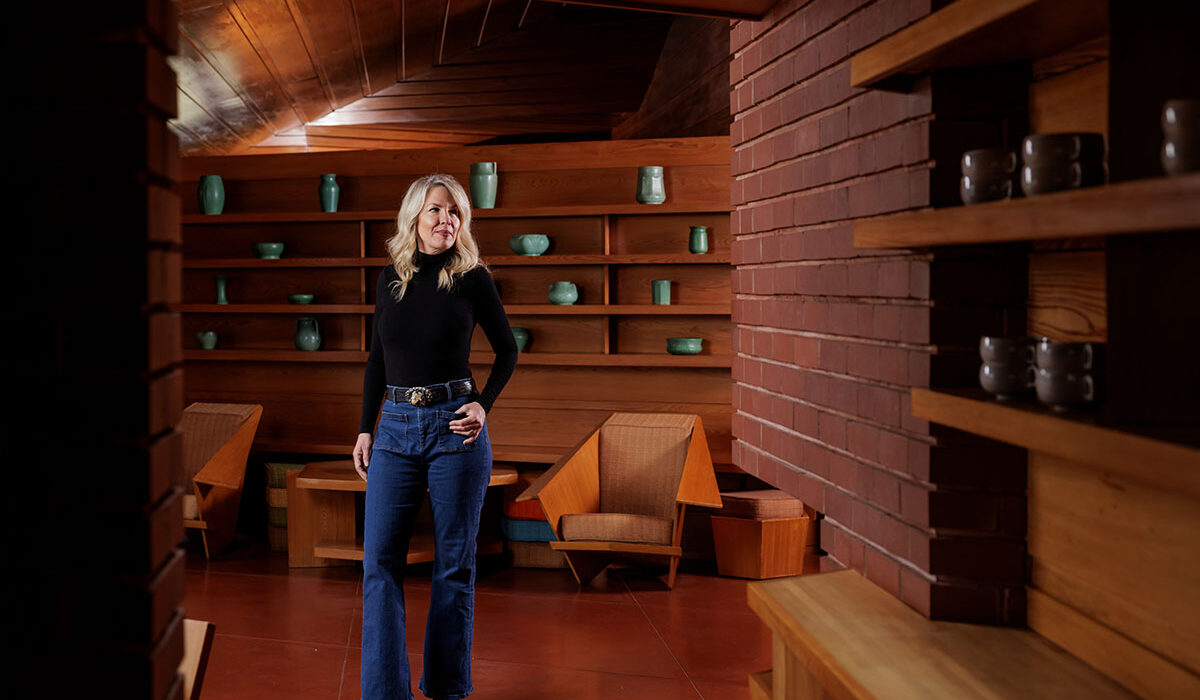 Kathryn Feldt, executive director of the Frank Lloyd Wright House in Ebsworth Park, in the living room of the home designed for and lived in by WashU alum Ruth Goetz Kraus, LLB ’31, and Russell Kraus.