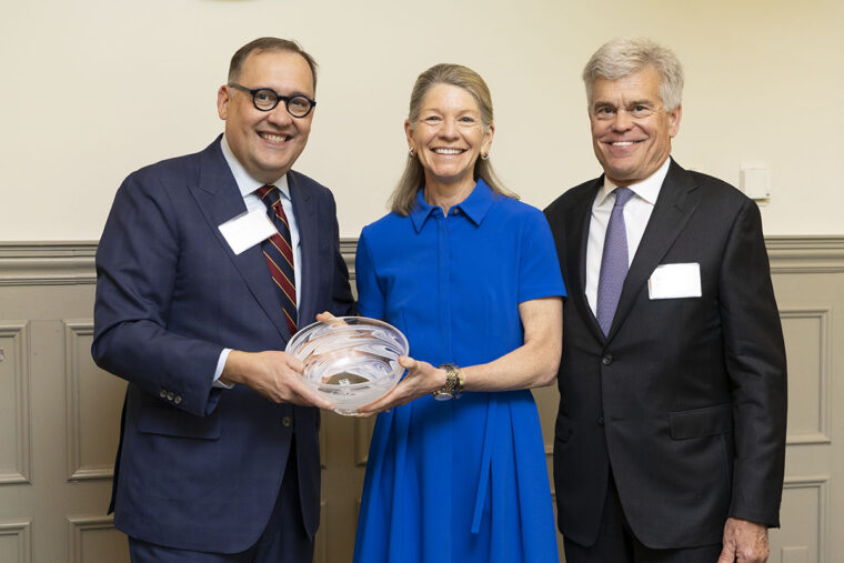 Chancellor Andrew D. Martin presents an award to Mary and Tom Stillman