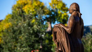 A George Washington statue stands in front of Olin Library. At the time of his death, Washing-ton, for whom the university is named, held 317 people in slavery.
