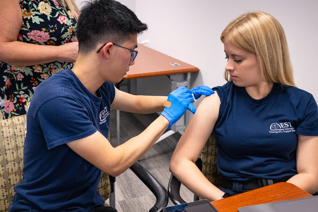 Student administers a vaccine