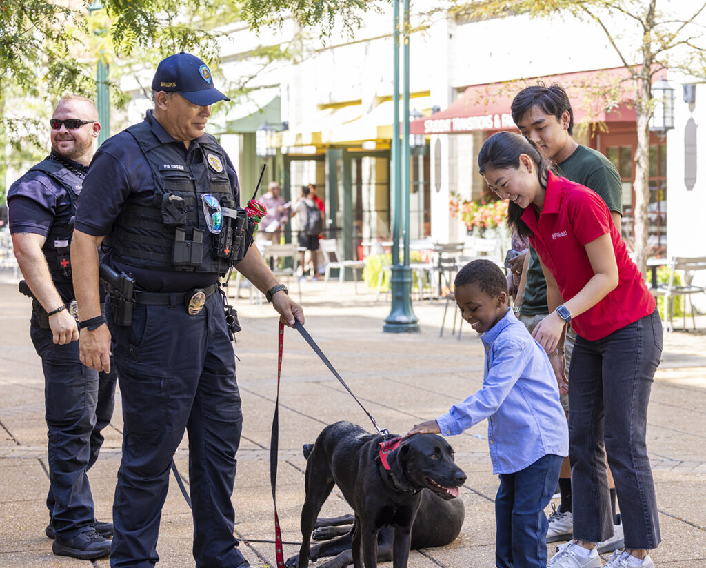 A young boy meets Brookie, a black comfort dog