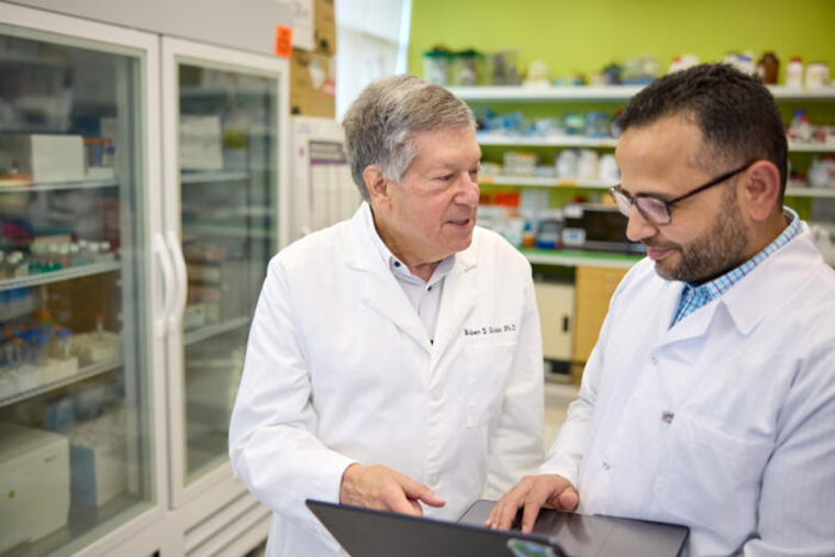 Immunobiologists Robert Schreiber (left) and Hussein Sultan