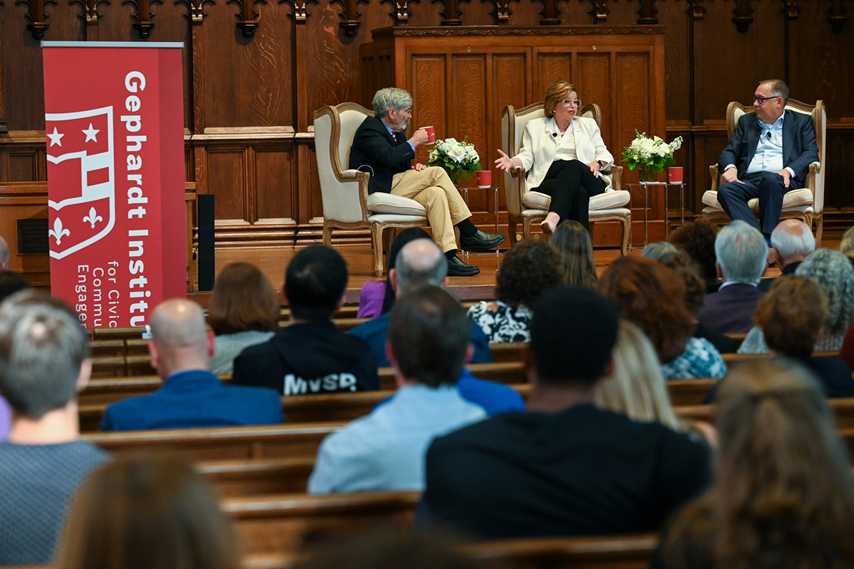 Chancellor Andrew D. Martin, Valerie Jarrett and Michael Isikoff engage in conversation