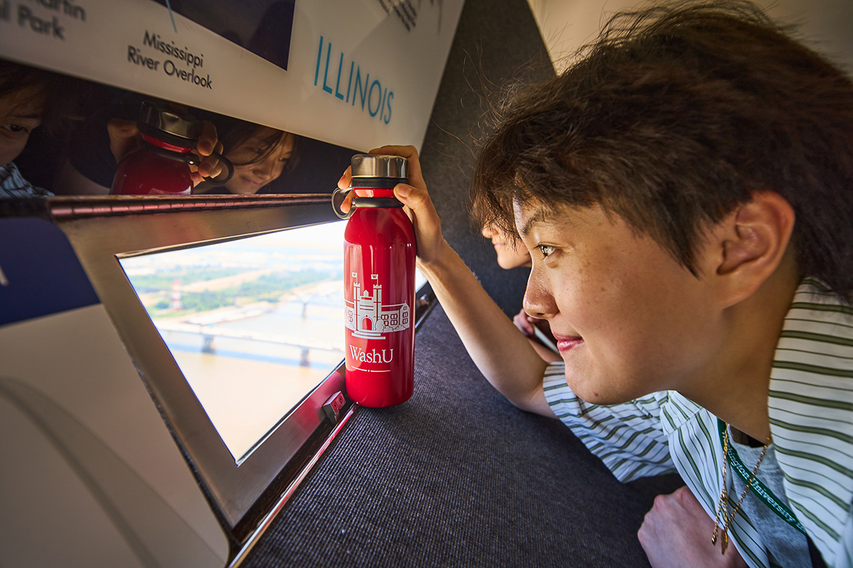 student looks out of window at top of Gateway Arch