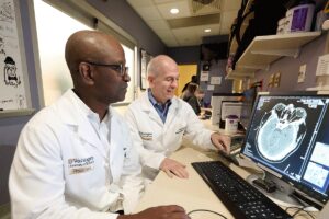 Opeolu Adeoye, MD, and Peter Panagos, MD, (right)
