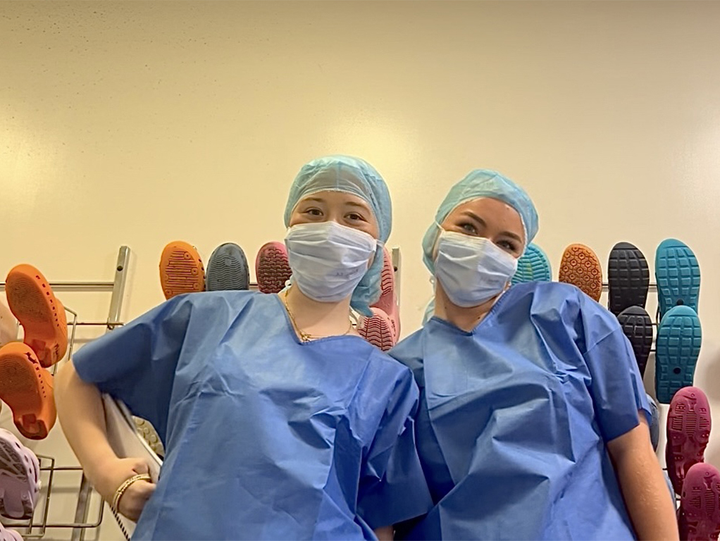 For her hospital internship, Anna Johnson (right), Arts & Sciences Class of ’26, chose the specialty of plastic and reconstructive surgery, including hand trauma surgery. Here, she’s photographed in full scrubs with fellow WashU student intern Annabelle Winssinger, Arts & Sciences Class of ’27. (Courtesy photo)