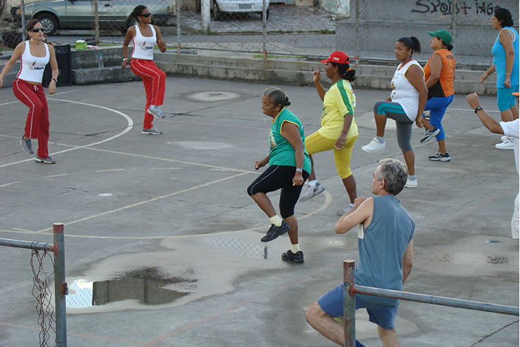 People in Latin America exercise in a publicly available fitness area.