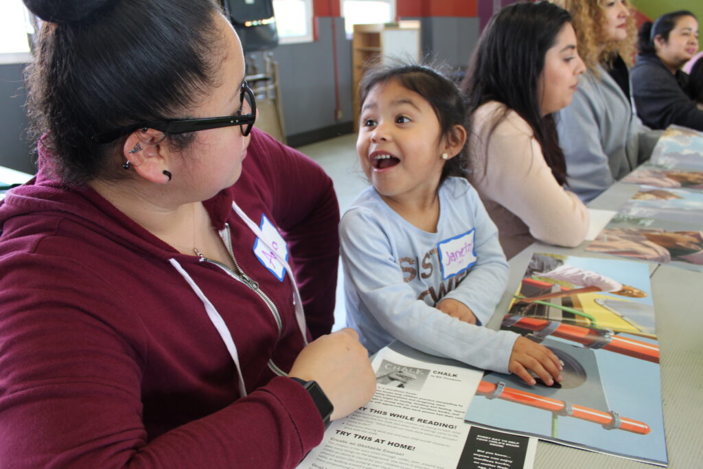 Families read together during Words Alive's Family Literacy Program. (Photo courtesy of Words Alive)