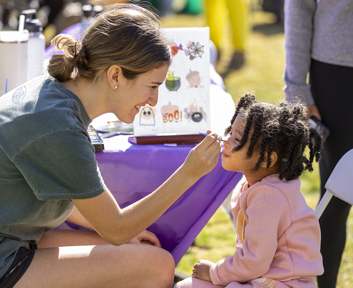 A child gets her face painted