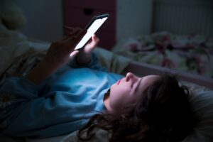 a teenager looking at their phone