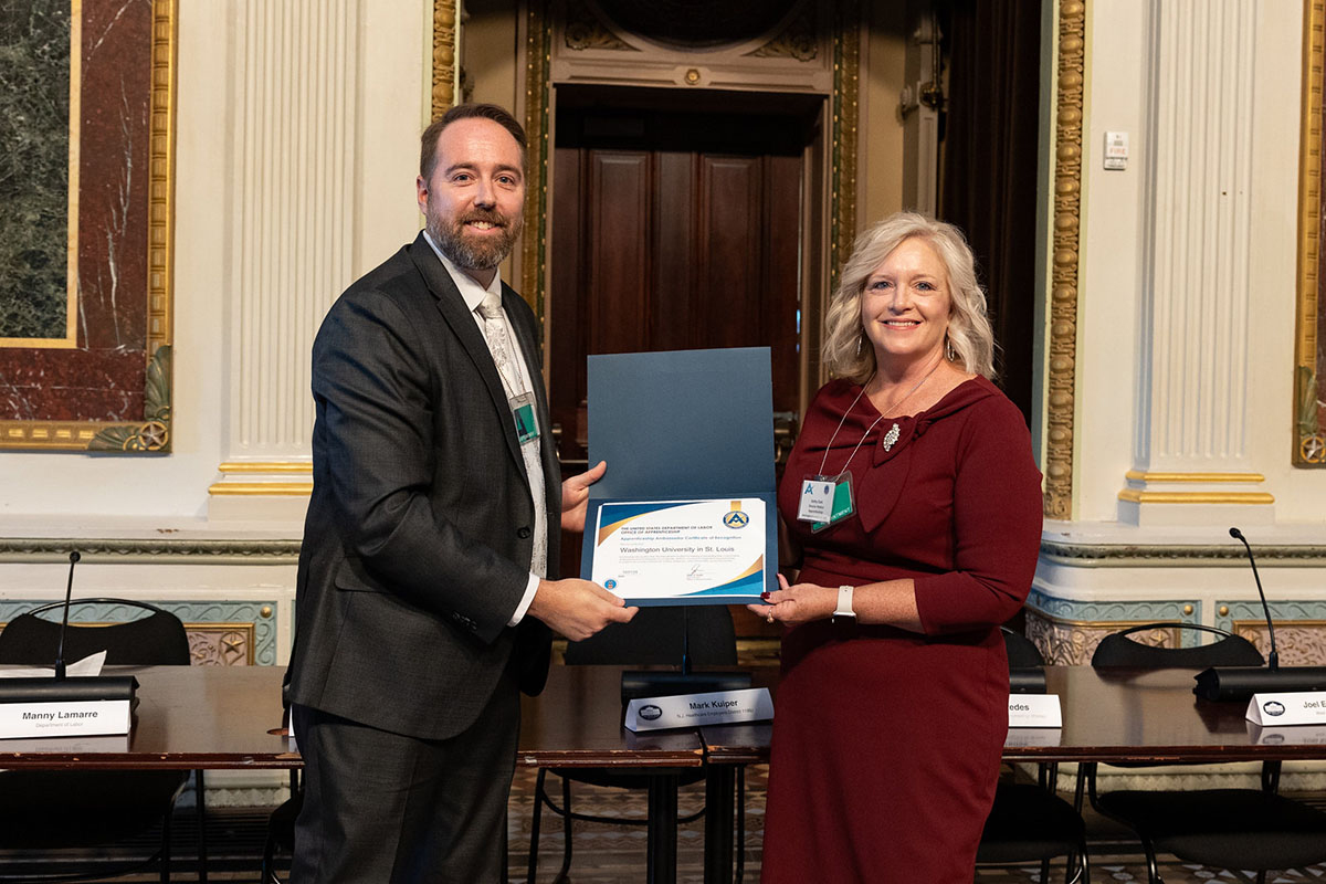 two people pose with certificate