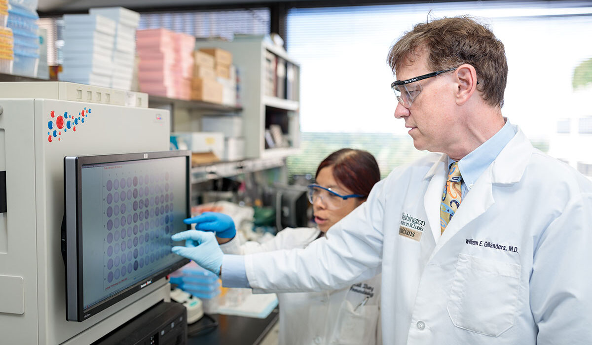 Doctors examine test results on computer.