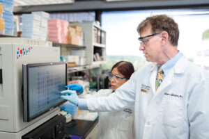 Doctors examine test results on computer.